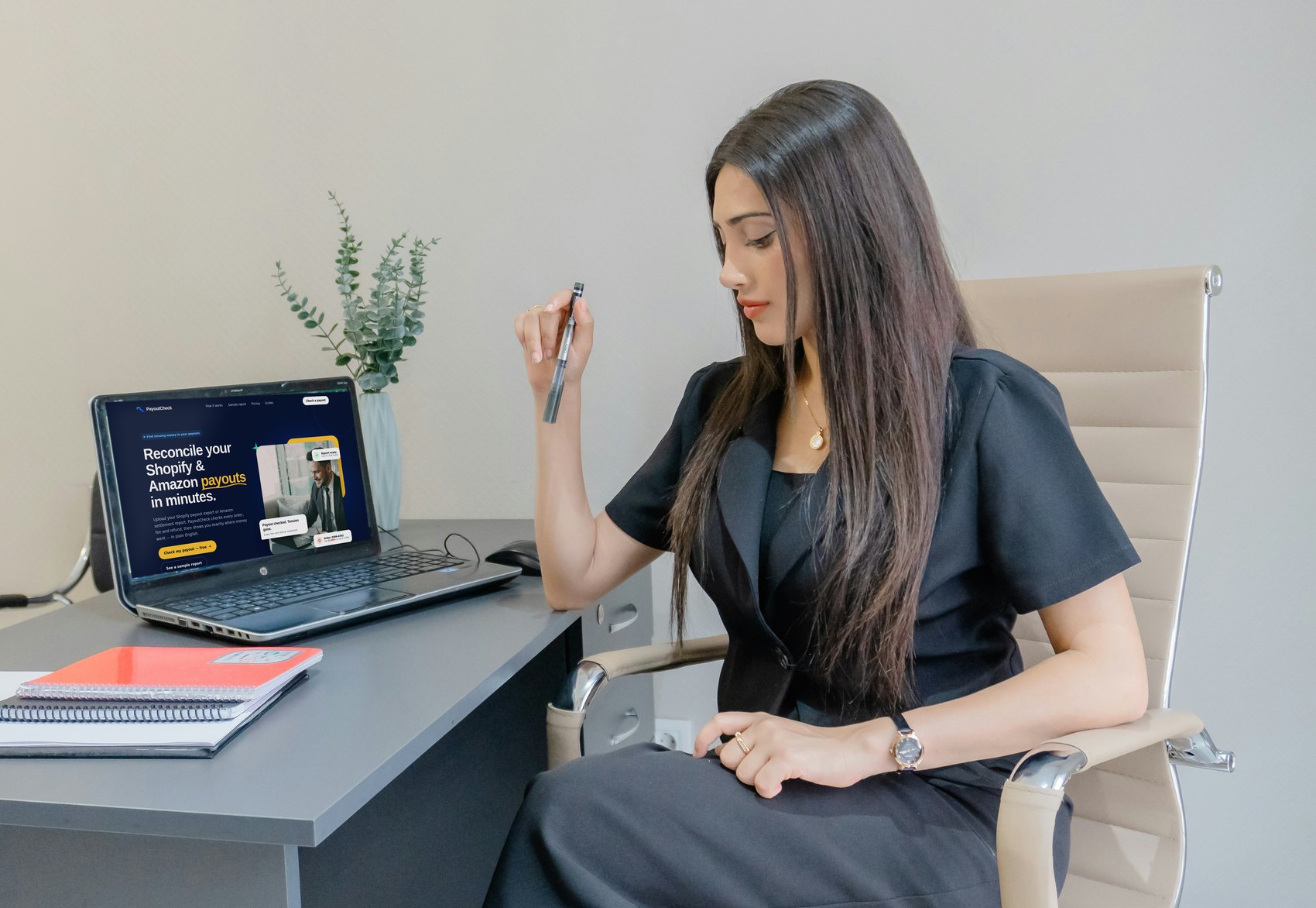A seller at her desk with PayoutCheck open on her laptop